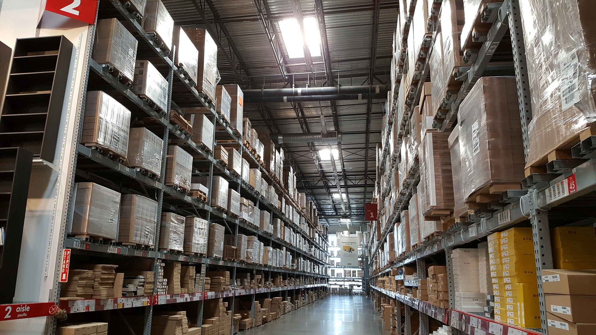 A warehouse with shelves filled with boxes floor to ceiling.